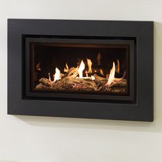 a wall mounted fireplace with flames burning in it