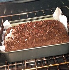 a cake is baking in an oven with paper towels on the rack next to it