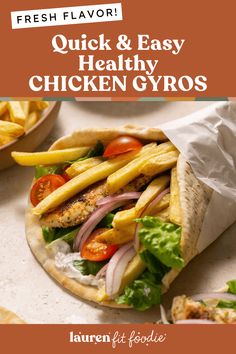 a chicken gyro sandwich with lettuce, tomatoes and french fries on the side