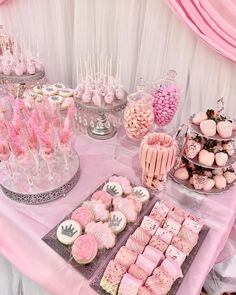 pink and white desserts are displayed on a table