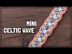 a close up of a bracelet on top of a wooden table with the words mini celtic wave written above it