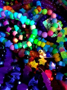 there are many beads and toys on the floor together in this pile, all different colors