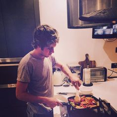 a man is preparing food in the kitchen