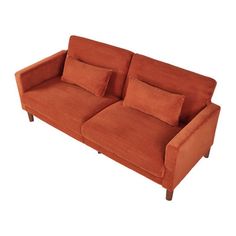 an orange couch sitting on top of a white floor