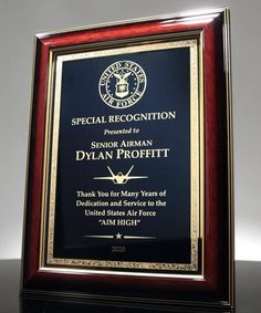 an award plaque for special recognition is displayed in front of a black background with gold trim