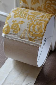 a roll of toilet paper sitting on top of a floor next to a piece of cloth