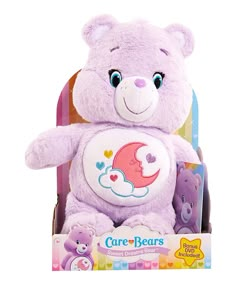 a purple teddy bear sitting in a box with its hands on the back of it