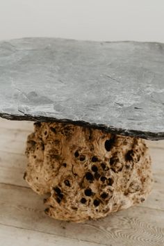 a piece of rock sitting on top of a wooden floor