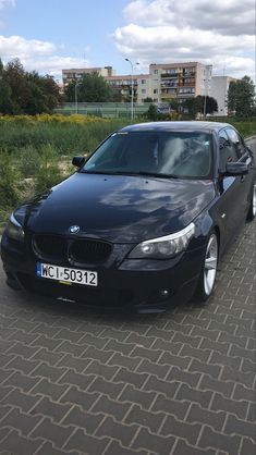 a black car is parked on the side of the road