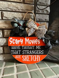 a sign that says scary movies have taught me that strangers are sketchy