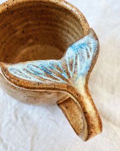 a ceramic cup that has been decorated with blue and white designs on the inside of it