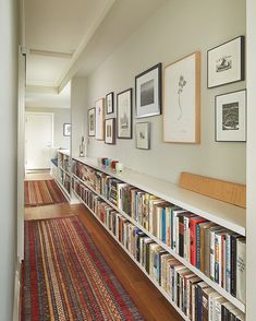 a long bookshelf filled with lots of books