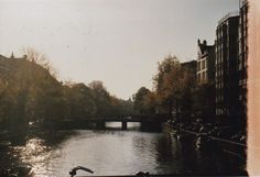 a river running through a city next to tall buildings