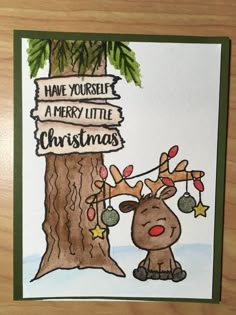 a handmade christmas card with a reindeer next to a tree and sign that says have yourself a merry little christmas