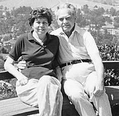 an old photo of two people sitting on a bench