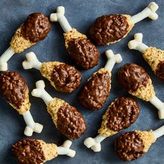 chocolate and marshmallow dog treats arranged on a blue surface with white bone decorations