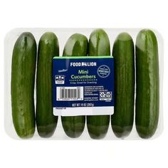 six cucumbers in a plastic container on a white background with a label for the product