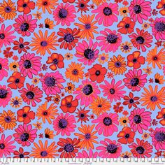 an orange and pink flower pattern on a blue background, with black dots in the center