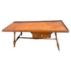 an old wooden table with two legs and a drawer on the top, against a white background