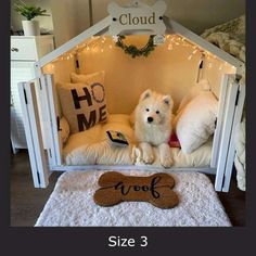 a small white dog sitting in its bed with a bone shaped pillow on the floor next to it