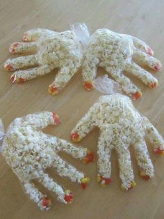 three hands made out of rice sitting on top of a wooden table