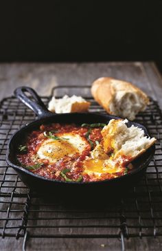 an iron skillet filled with eggs and bread