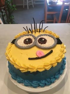 a birthday cake decorated to look like a minion