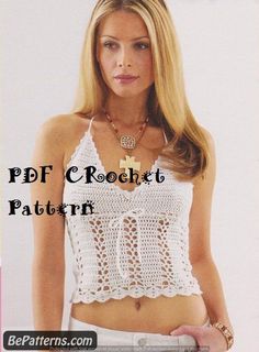 a woman wearing a white crochet top is posing in front of the camera