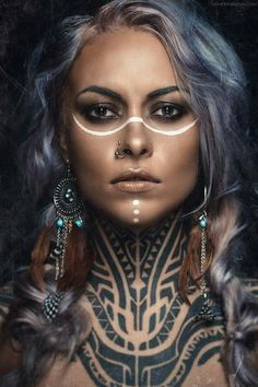 a woman with tattoos and piercings on her chest is looking at the camera while wearing glasses