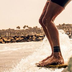 a man riding a wave on top of a surfboard