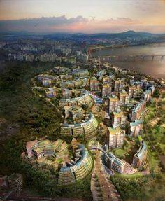 an aerial view of a city with lots of tall buildings and green trees on the hillside