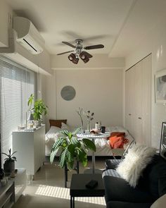 a living room filled with furniture and a ceiling fan