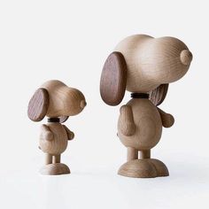 two wooden dogs standing next to each other