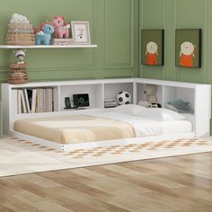 a bedroom with green walls and white bedding, bookshelves on the wall