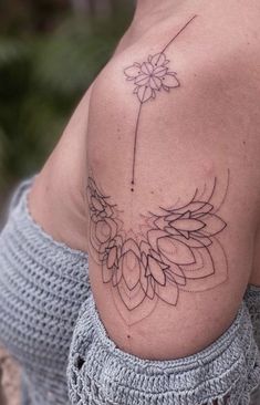 a woman with a flower tattoo on her shoulder