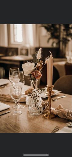 the table is set with flowers and candles