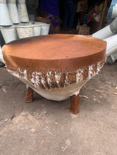 a large wooden table sitting on top of a dirt ground