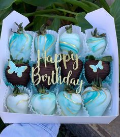 a box filled with chocolate covered strawberries sitting on top of a table