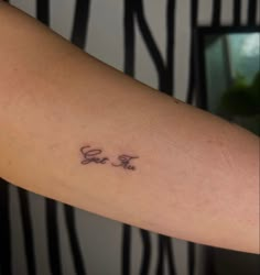 a person with a tattoo on their arm that says, go to the moon and fly