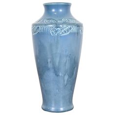 a light blue vase with designs on the outside and inside, sitting against a white background