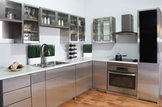 a kitchen with stainless steel appliances and wooden floors