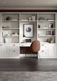 a desk with a laptop on top of it in front of some bookshelves