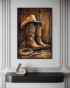 a painting of two cowboy boots and a rope on a shelf in a room with white walls