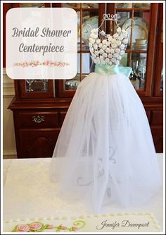 the bridal shower centerpiece is made from tulle and white flowers on it