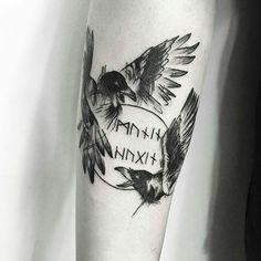 a black and white tattoo with two birds on it