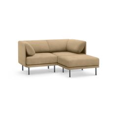 a beige sectional couch sitting on top of a white floor