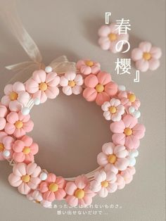 a pink and white bracelet with flowers on it