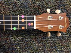 an ukulele is laying on the carpet