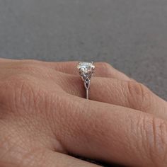 a woman's hand with a diamond ring on it