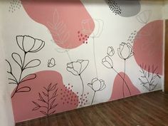 a wall with flowers painted on it in an office building or business space, next to a wooden floor